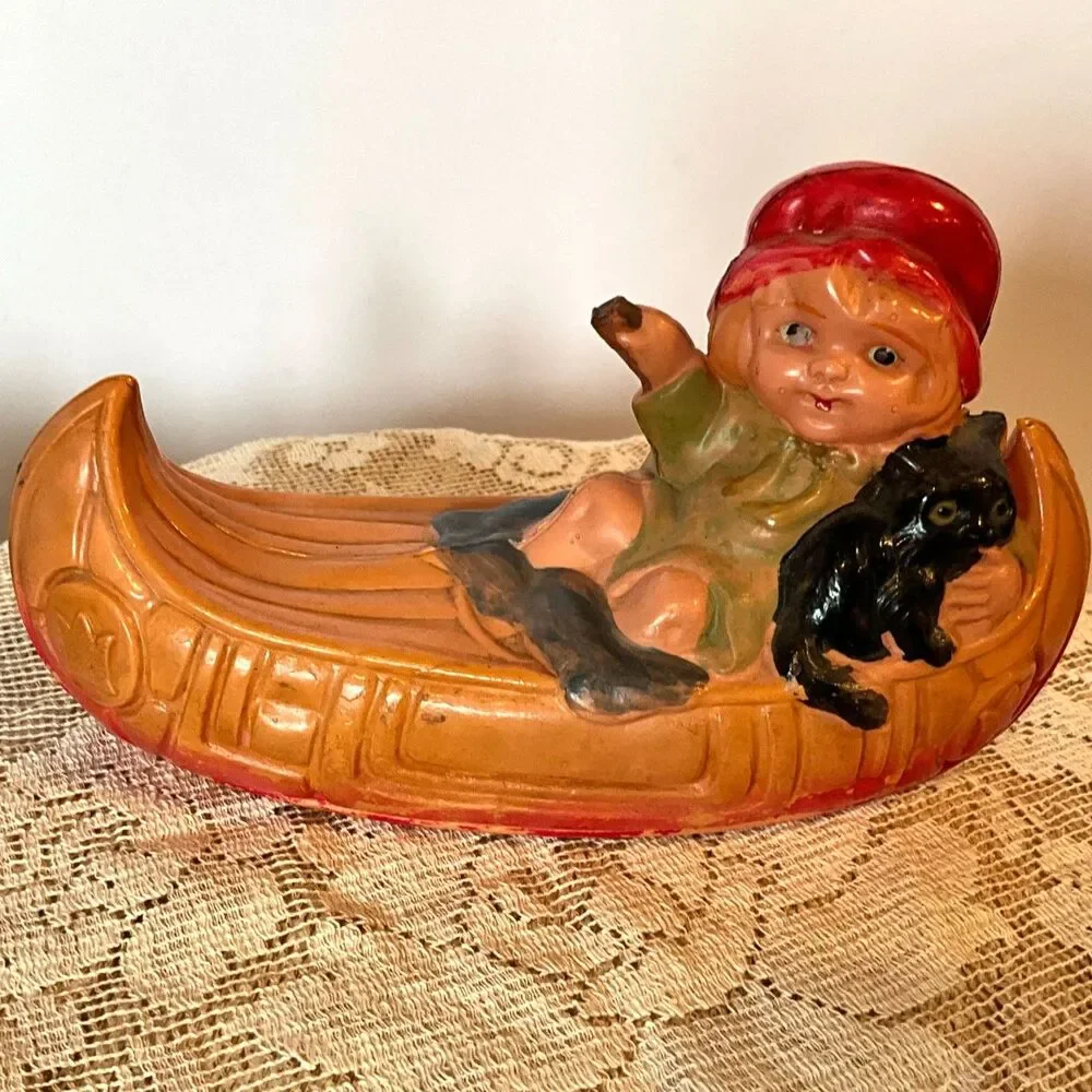 Rare 1920's Antique celluloid toy girl in a canoe; don't miss her!